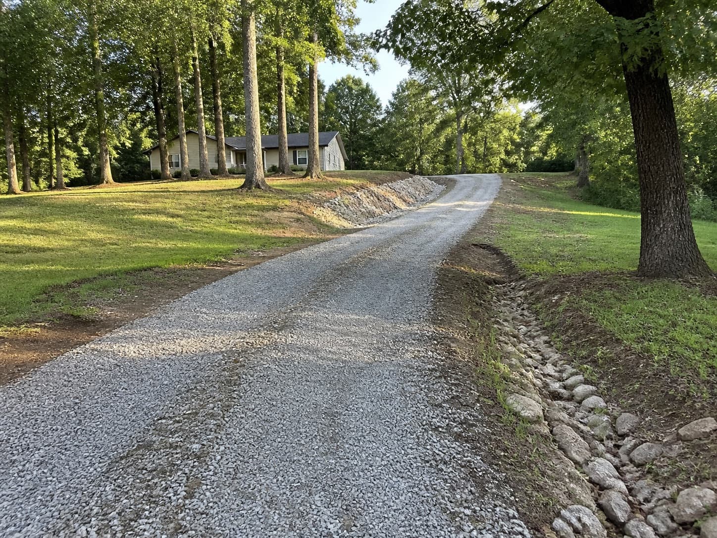 Rural private gravel driveway in a wooded residential setting